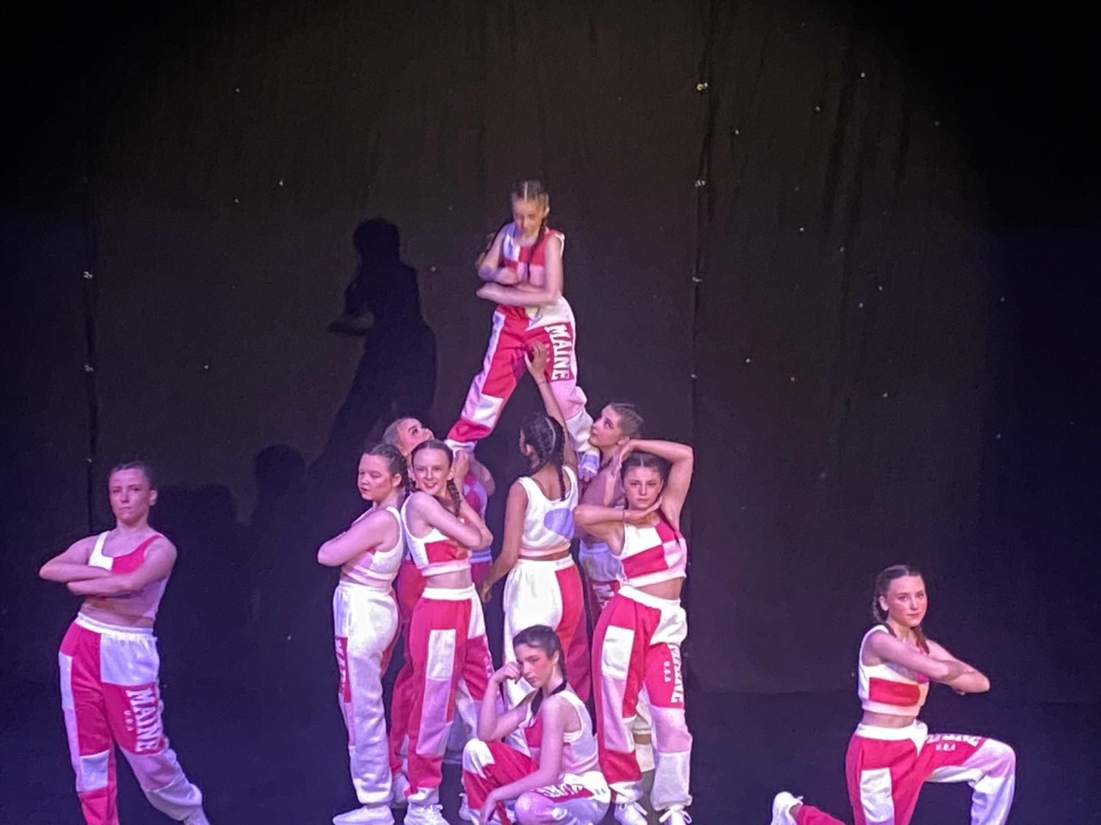 Ballet group performing in white costumes at Clairemarie’s show